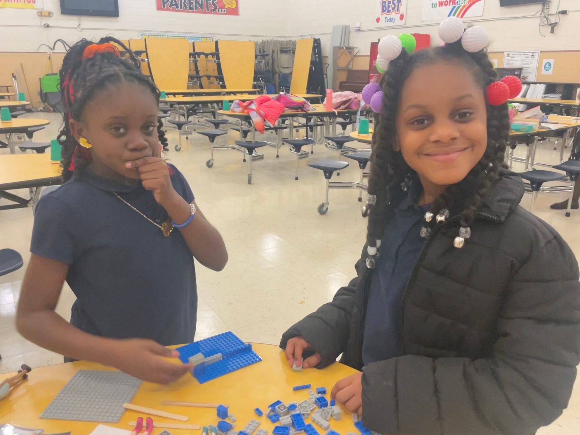 During a bi-weekly troop meeting, third grade girls at St. Helena Elementary in Norfolk completed the final requirements of their Board Game Design Challenge, part of a STEM badge series on mechanical engineering.