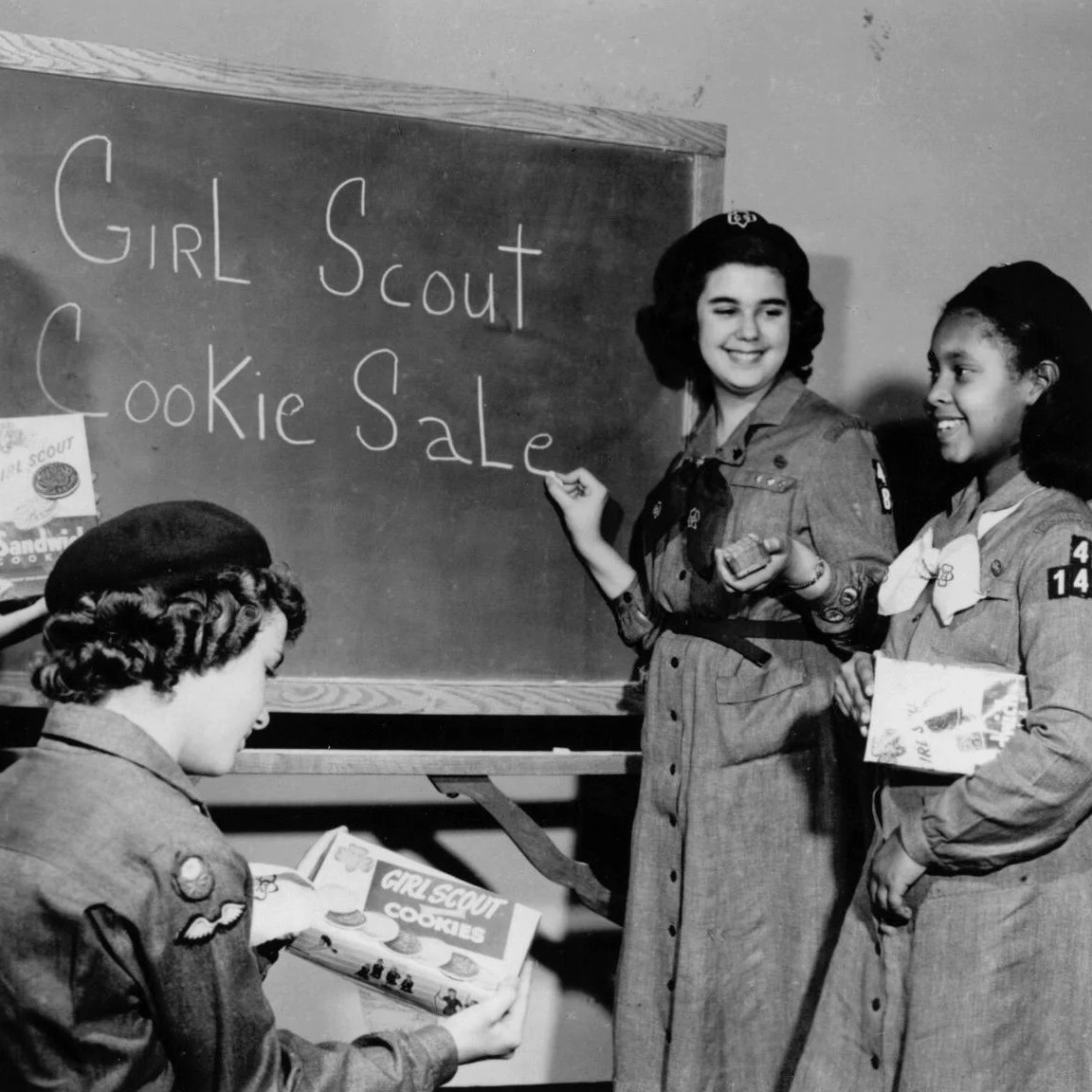 Girl Scouts at blackboard planning a Girl Scout Cookie Sale