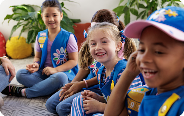 Girl Scouts giggling together at a troop meeting