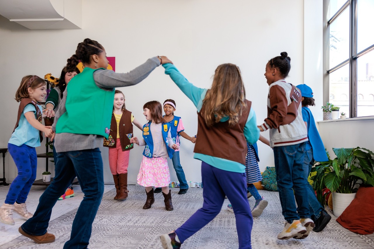 Girl Scouts play an indoor game together