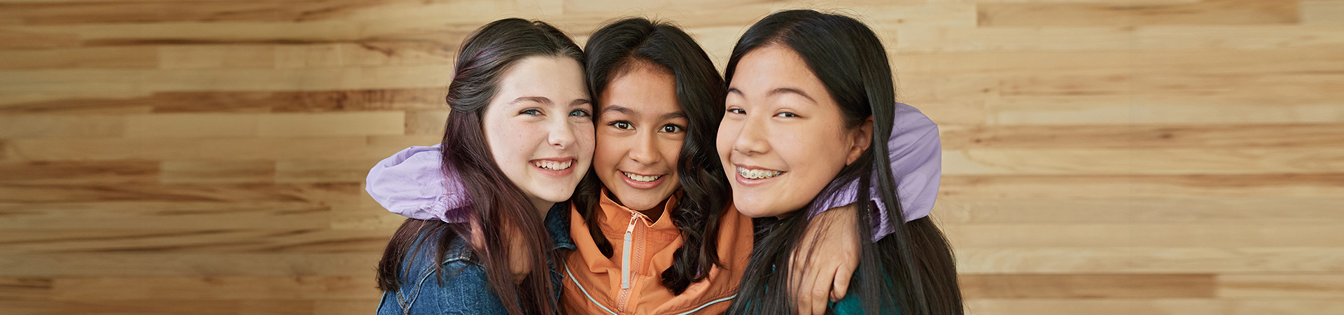  group of girl scouts smiling and hugging 
