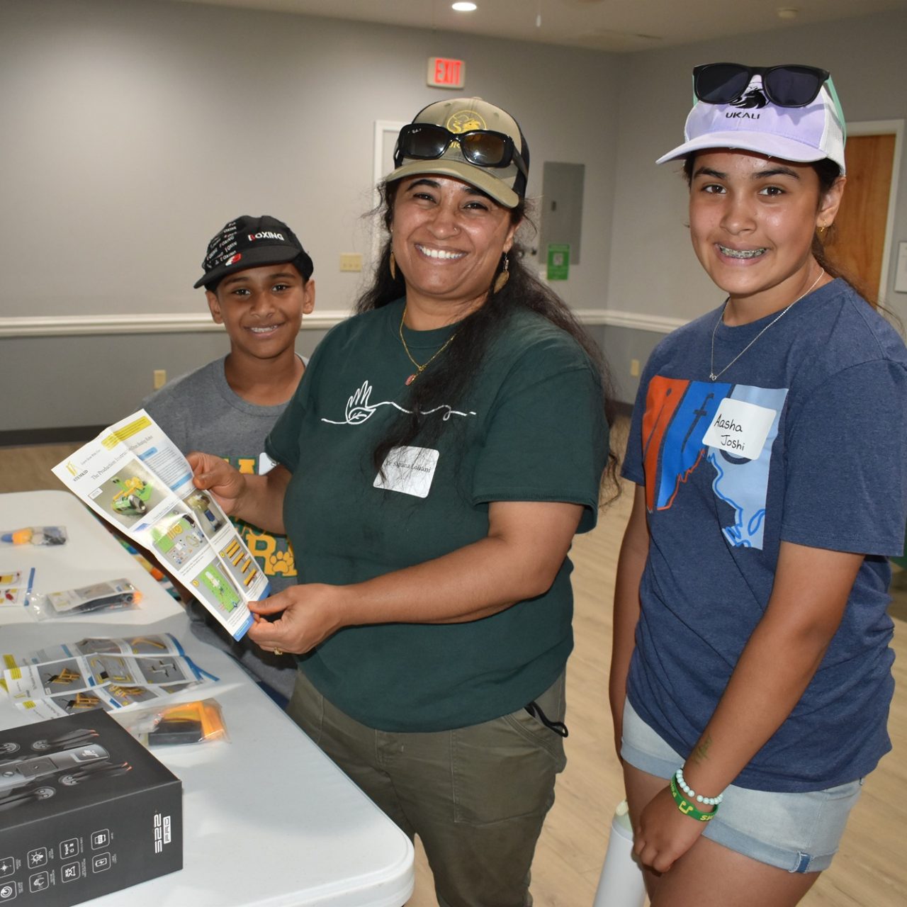 a family looks over the Robotics badge kit