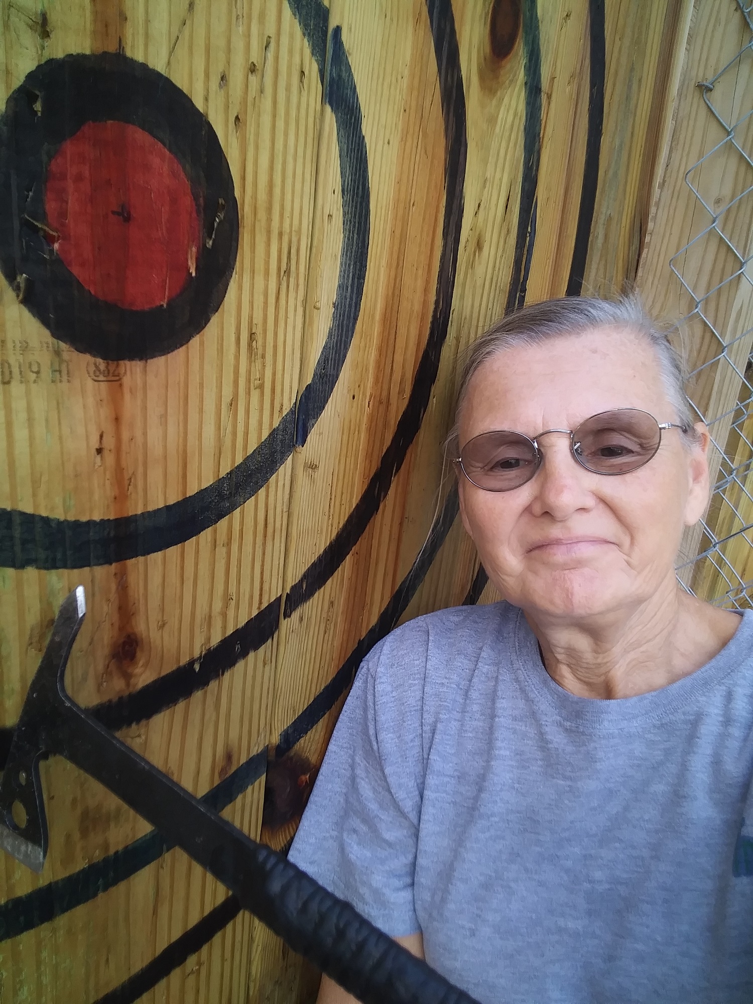 Judy on the axe-throwing range at camp