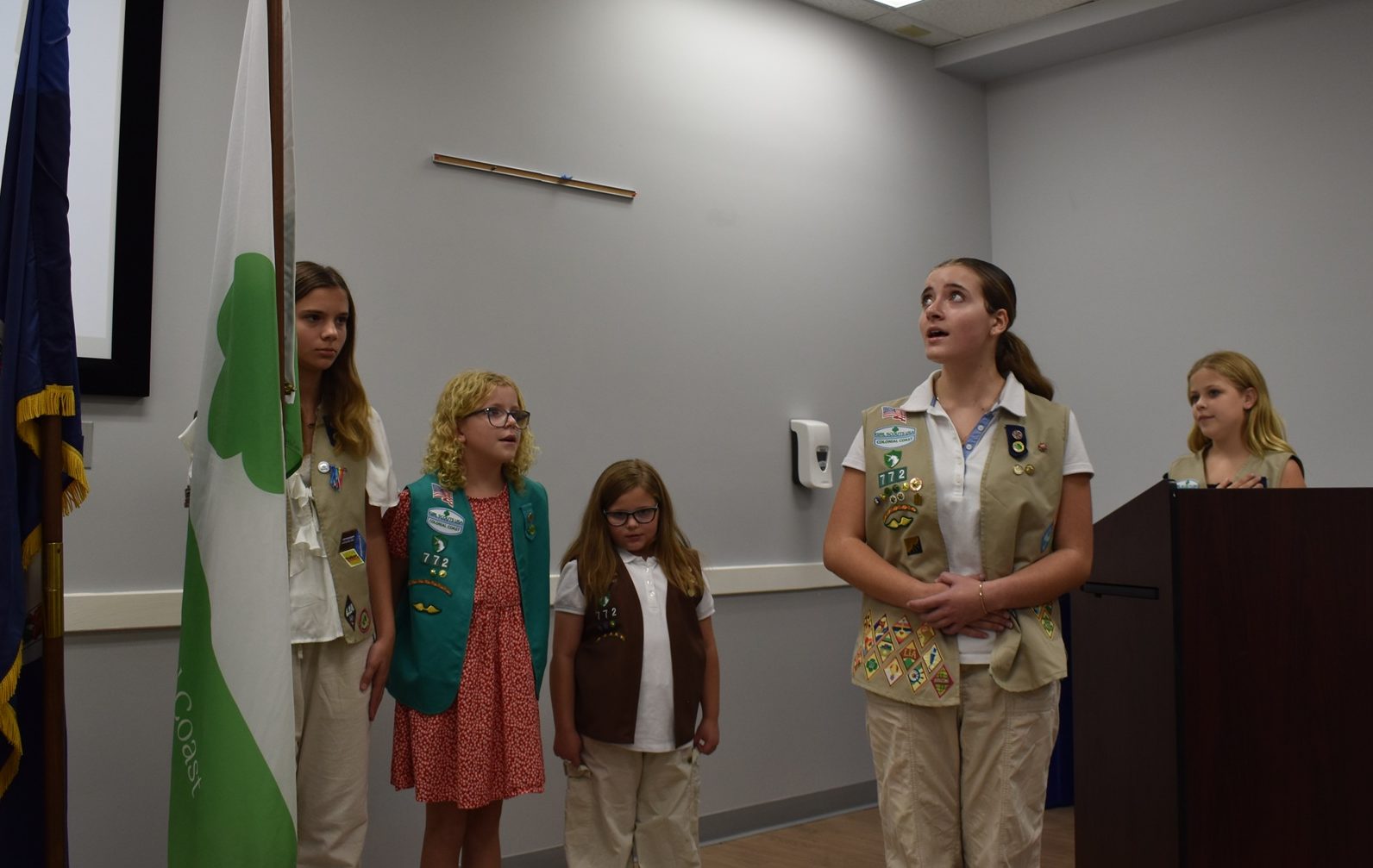 Troop 772 performed the opening flag ceremony and Girl Scout Cadette Addie sang the national anthem