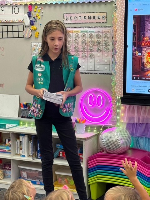 Girl Scout Junior Alice presented safety workbooks to local Kindergarteners