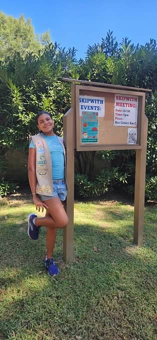 Girl Scout Cadette Kaylani with her finished sign