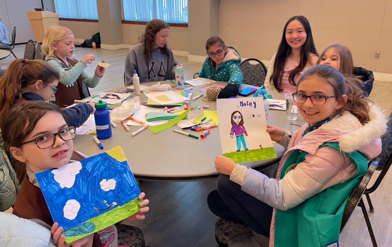 Girl Scout Brownies and Juniors work on a badge activity with the Kappa Deltas