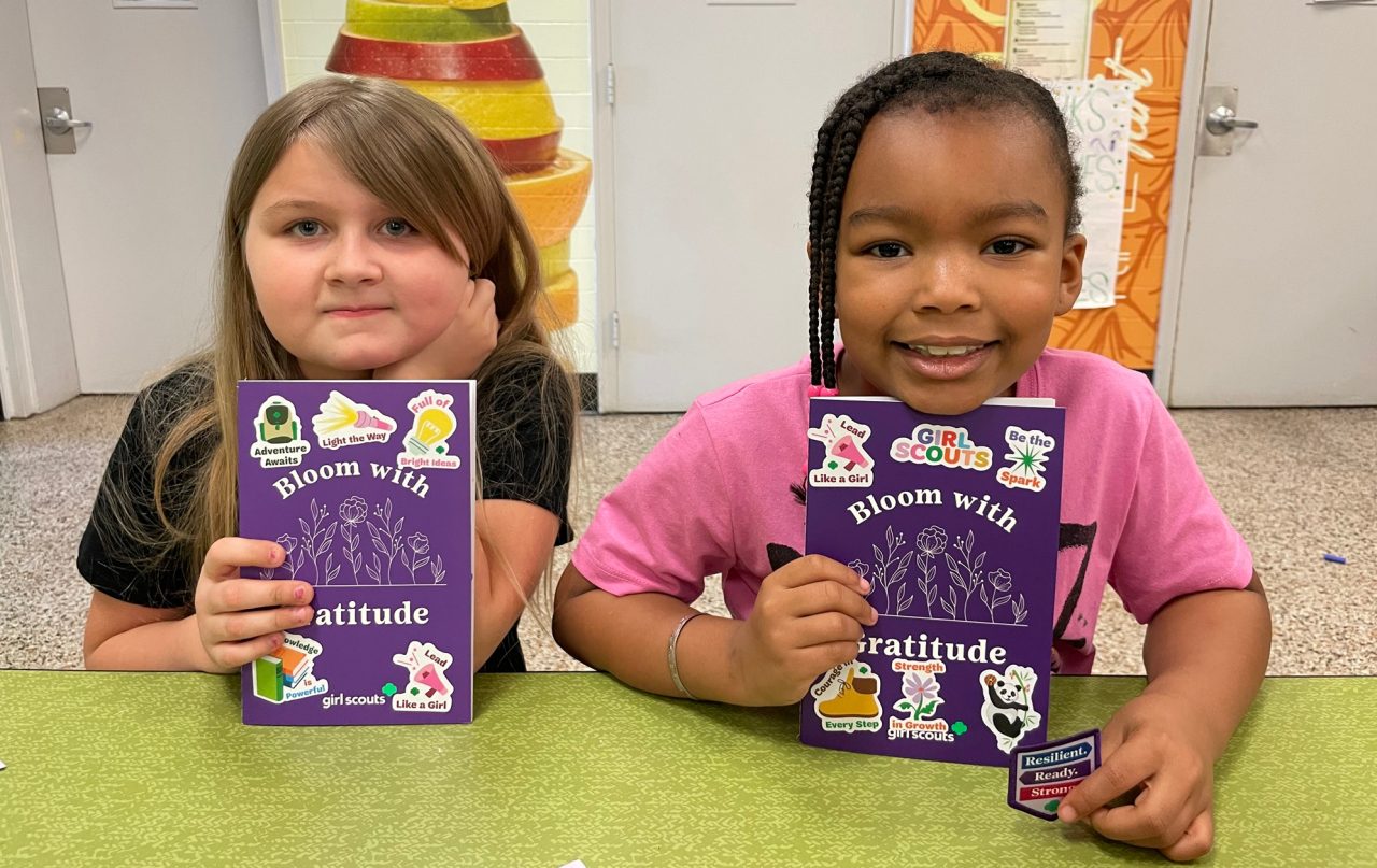 Girl Scouts pose with their mental wellness journals