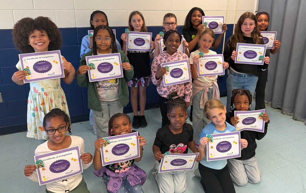 Suffolk Community Troop Girl Scouts pose with their program certificates