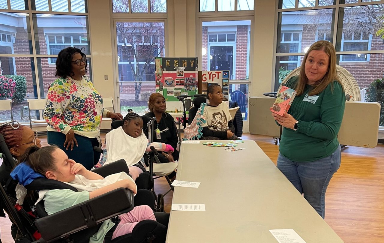 Heidi leads a meeting of Troop 151 at St. Mary's Home for Disabled Children