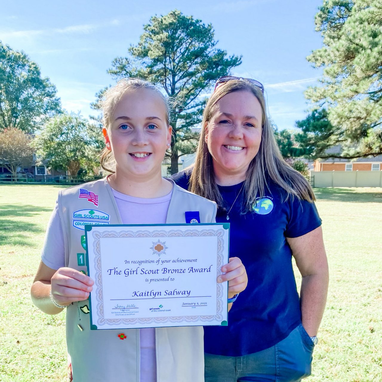 Heidi and daughter Kaitlyn pose with Kaitlyn's Girl Scout Bronze Award Certificate
