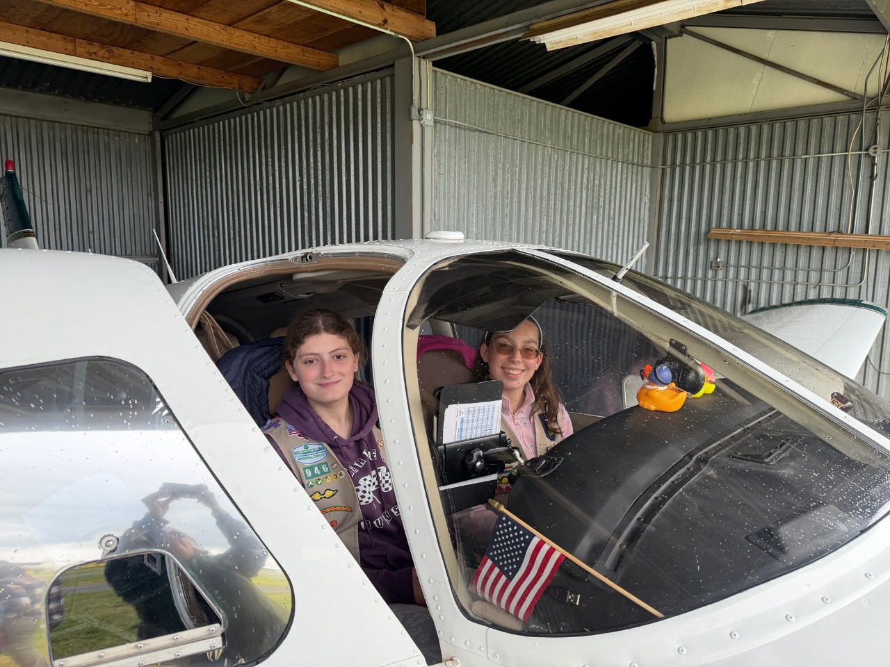 Girl Scout Cadettes Emma B. and Michaela A. pose in the cockpit