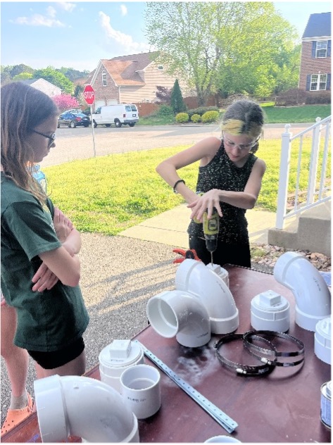 Girl Scout Cadettes used power tools and worked to build their PVC tubes