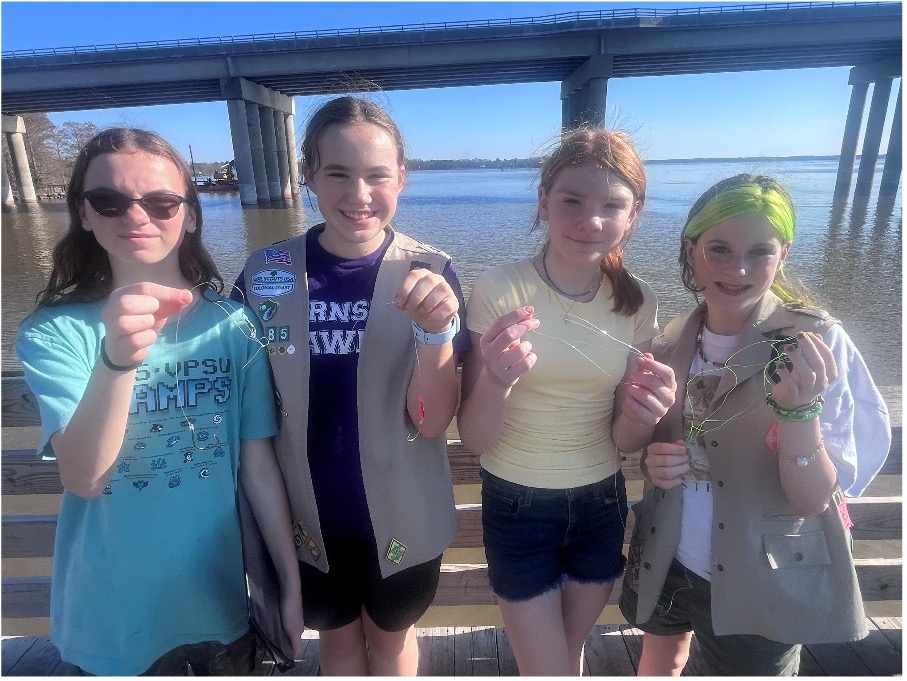 Girl Scout Cadettes hold up troublesome discarded fishing line