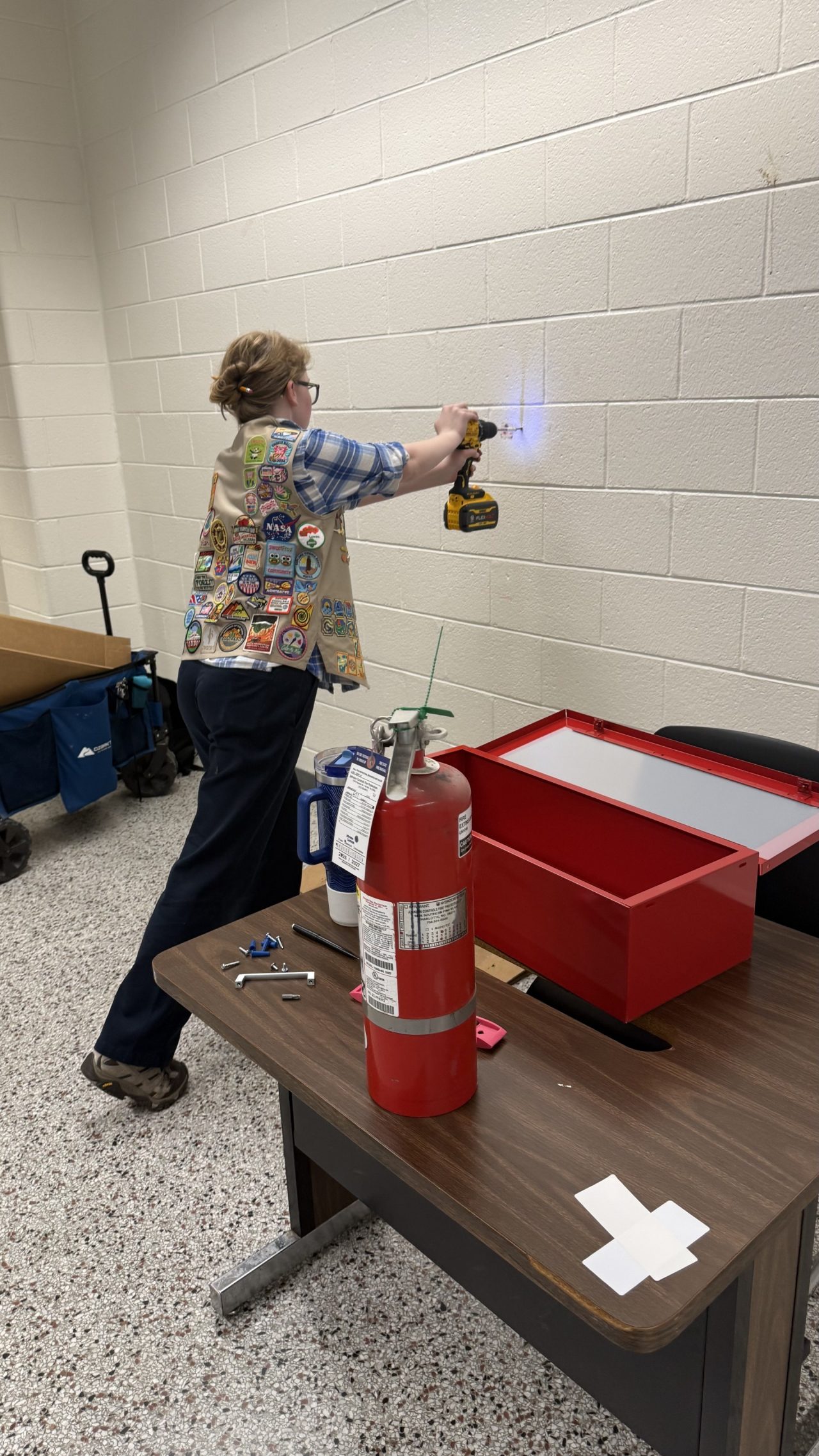 Gold Award Girl Scout Aliya installed fire extinguisher cabinets at her school
