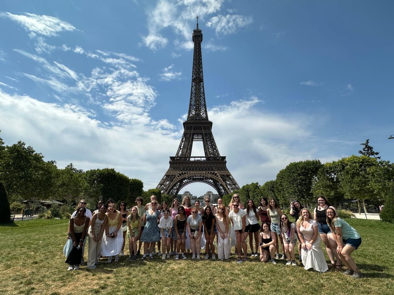 Girl Scouts pose in front of the Eiffel Tower