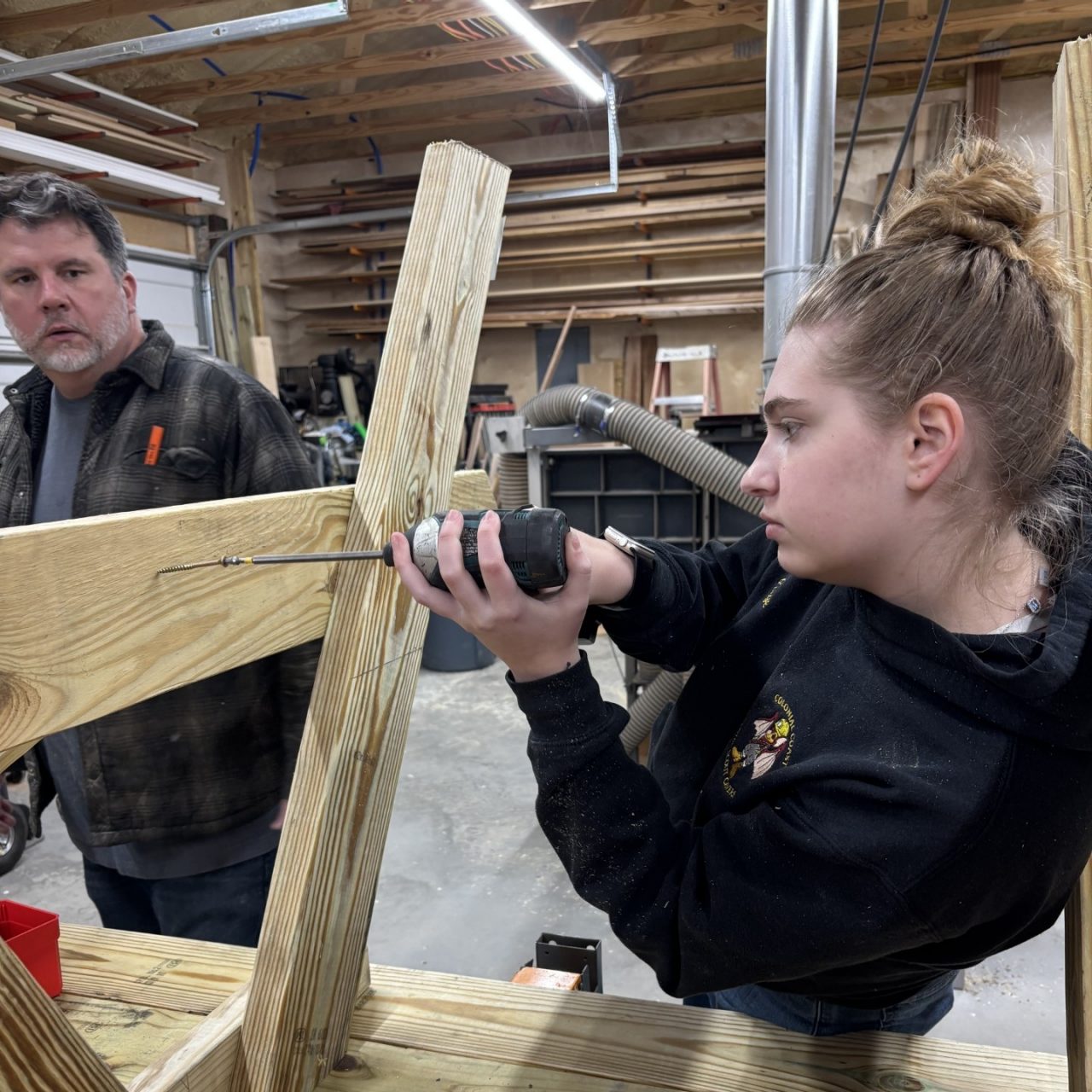 Paige worked with a volunteer carpenter to learn and use new hands-on skills.
