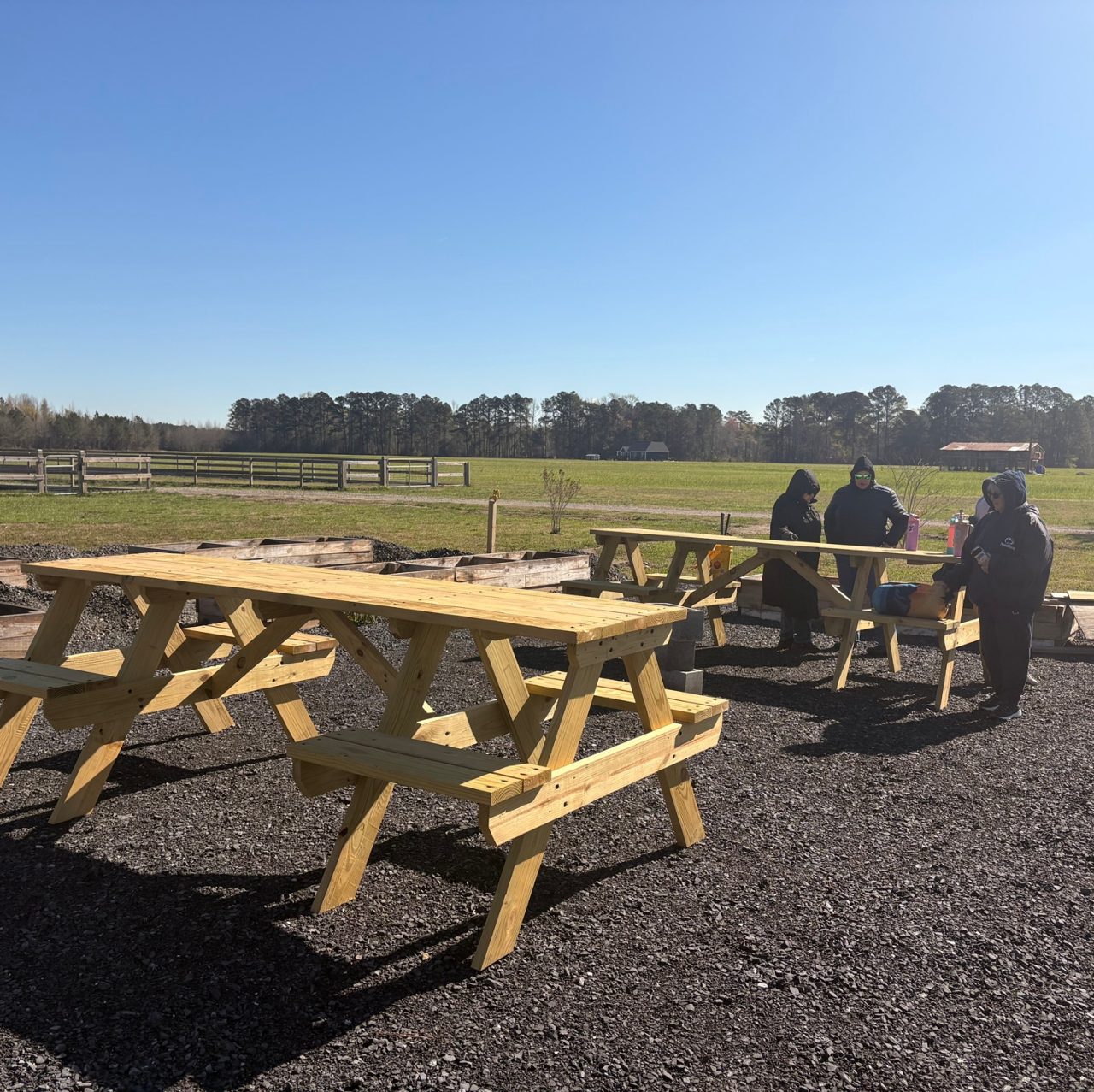 Paige helped to build custom picnic tables for the garden.