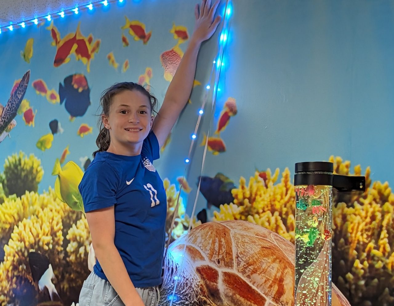Girl Scout Cadette Lauren E. hanging some lights