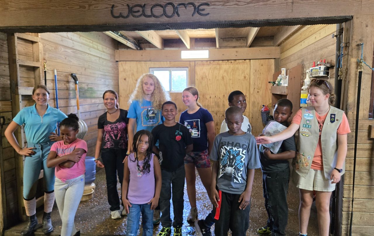 Girl Scout Cadette Emma with kids from Mercy Drops Dream Center in Portsmouth