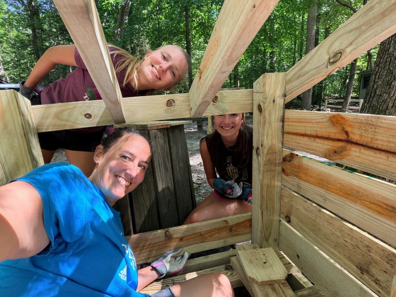 Girl Scout Cadettes Ella D. and Sarah S. working with a volunteer