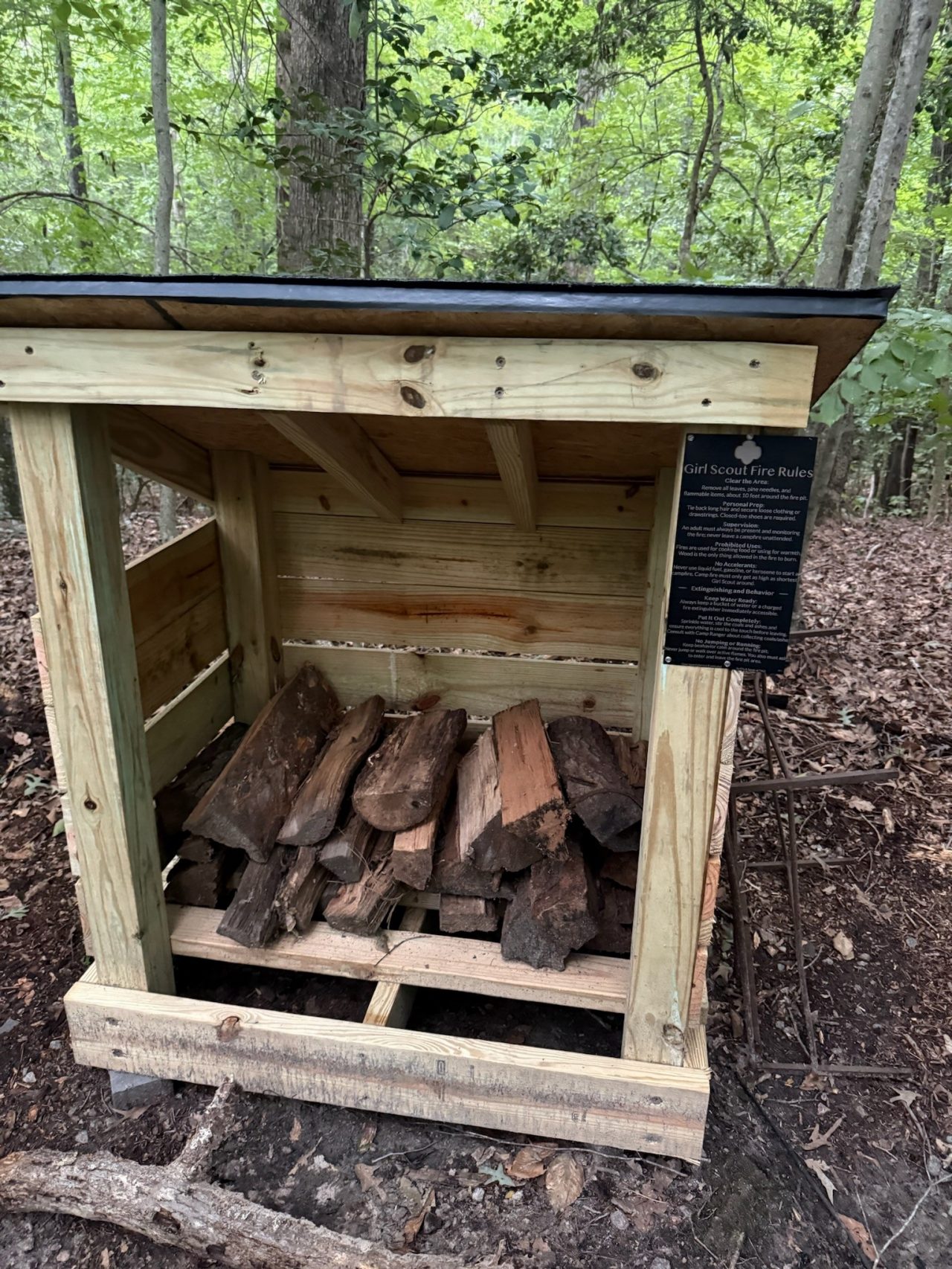 a finished firewood shelter in use at Camp Skimino