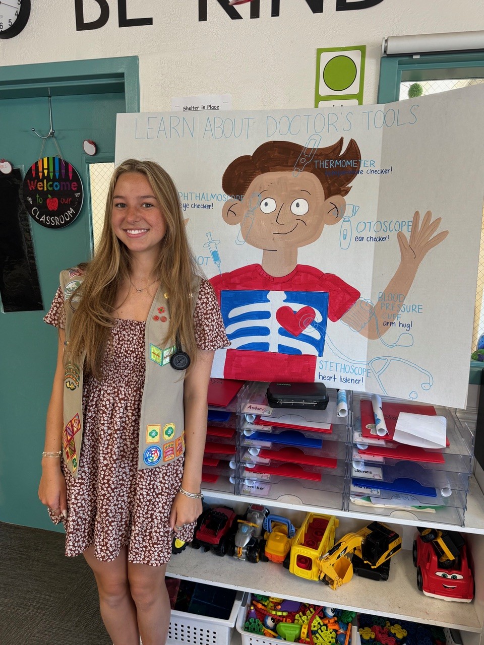 Girl Scout Ambassador Madison poses with her educational presentation board
