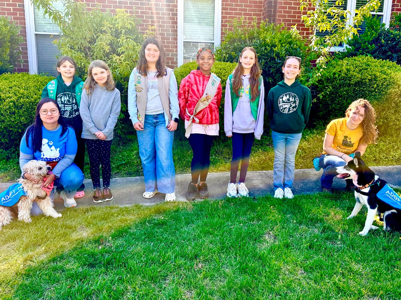 Girl Scouts pose with staff and adoptable dogs from Chesapeake Humane Society