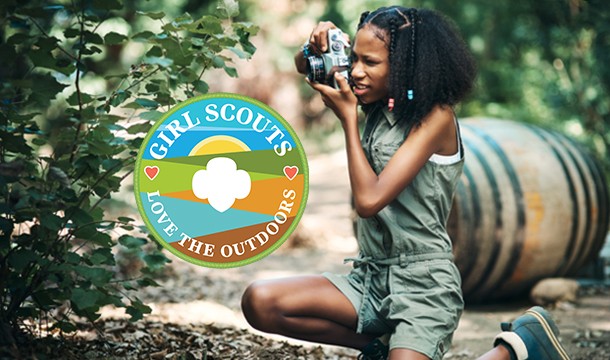 Girl Scout taking photos outdoors