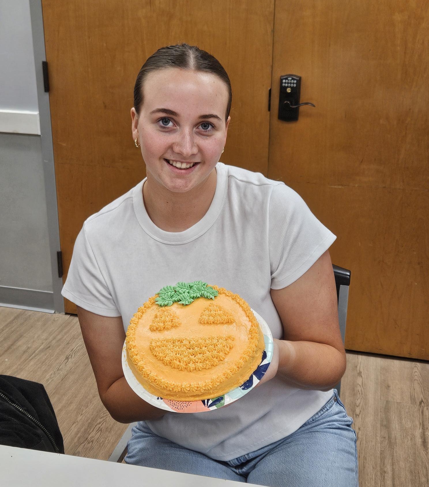Girl Scout at a meeting of the GSCCC Cooking Club shows off her decorated cake