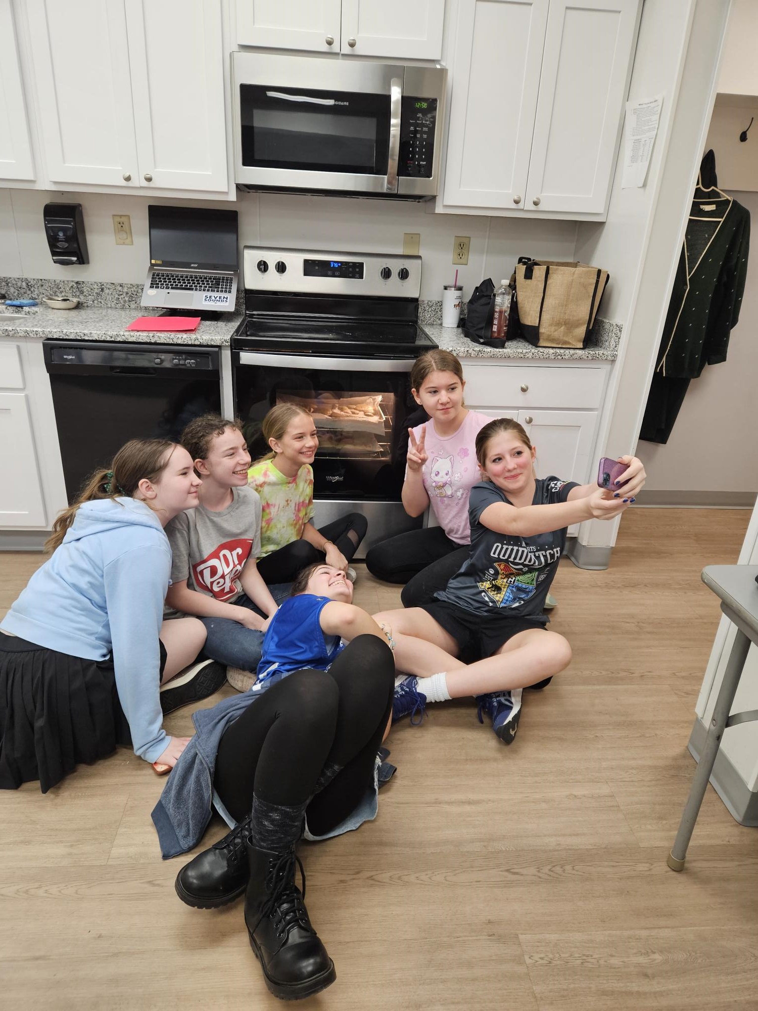 GSCCC Cooking Club taking a selfie in the kitchen at A Place for Girls