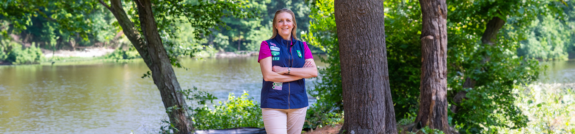  Girl Scout Volunteer in uniform standing outdoors and smiling 