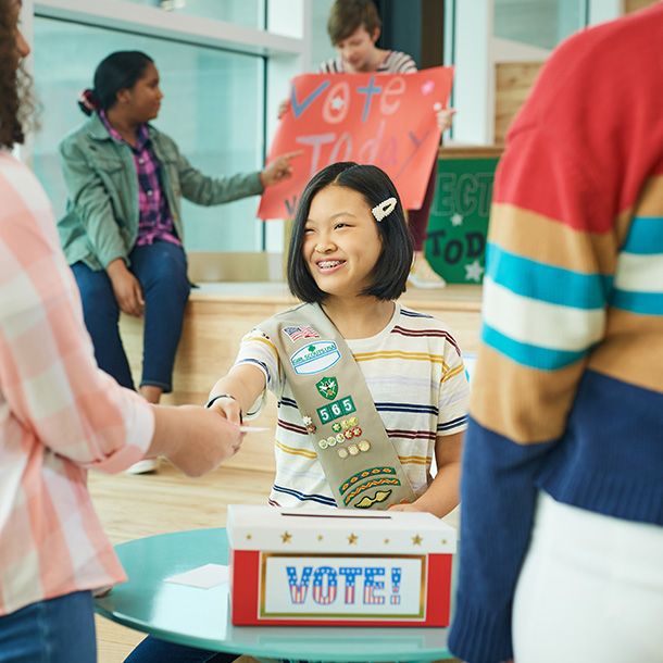 Girl Scout greeting people at an event