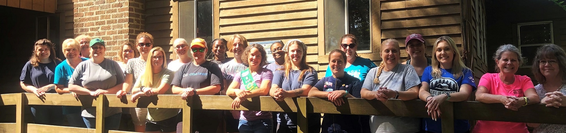  Diverse group of Girl Scout alums standing together and smiling 